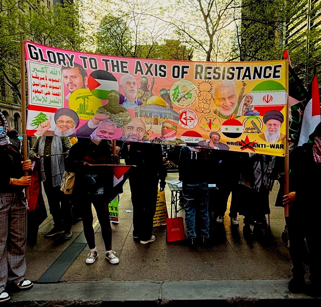 Photo: A May 2025 event organized by the Bronx Anti-War Coalition in Manhattan where participants carried a banner with logos and flags or terror groups, and with images depicting terror leaders. (Telegram)