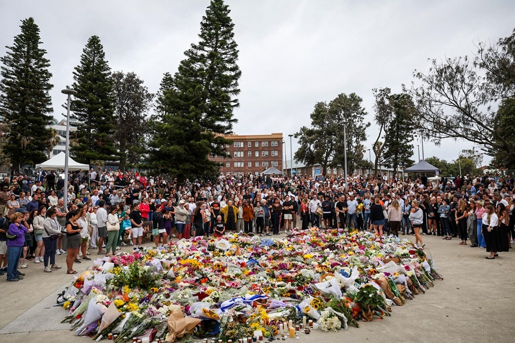 Photo: Mourners gather to lay flowers at Bondi Beach on December 15, 2025, in Sydney, Australia, where 15 were killed and dozens were injured when two attackers opened fire at a Hanukkah celebration. (Izhar Khan/Getty Images)