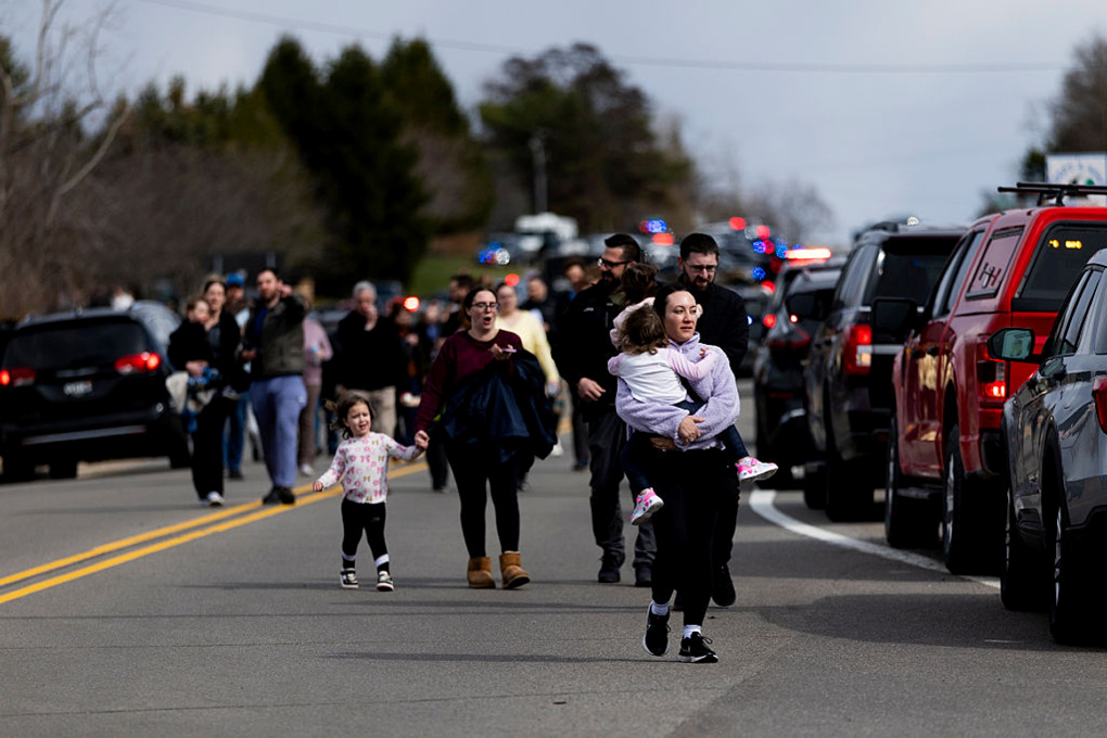 Photo: Law enforcement escorts families and their children to their cars following an active shooter near Temple Israel on March 12, 2026, in West Bloomfield, Michigan. (Emily Elconin/Getty Images)
