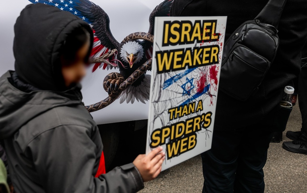 A child joins protesters as they gather in Times Square for a Quds Day rally on March 13, 2026, in New York City