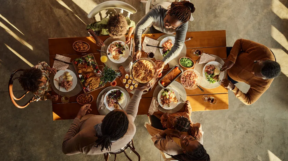 Family eating dinner at the table shot from above