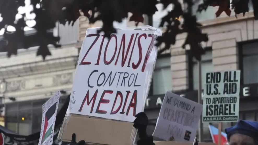 Photo: Seattle, Wash. -- A protester held a sign reading "Zionist control the media" at a protest in October.