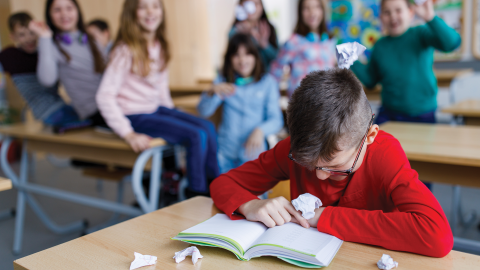 Boy being bullied inside the classroom