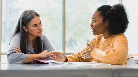Middle school student talking with teacher
