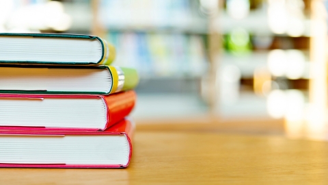 Colorful books stacked on a table