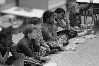 Young Kids Sitting on Classroom Floor